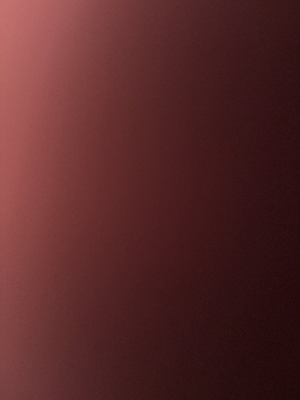Solid gradient background transitioning from light to dark red, no person or object visible.