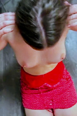 Person with dark hair in a red top posing from behind.
