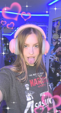 Woman with blonde hair and headphones sticks out her tongue in a playful pose.