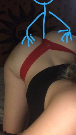 Curvy woman lying on her side wearing red lace thong and black top, with a blue stick figure drawn over her back.