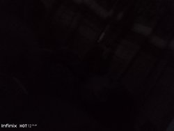 Dark, indistinct image with no clear subject or discernible features.