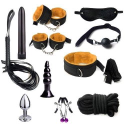 Assortment of black and metallic bondage and pleasure toys including cuffs, blindfold, rope, flogger, dildos, and