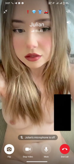 A blonde woman with long hair is topless in a video call.