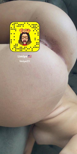 Close-up of a person's bare buttocks with a Snapchat QR code overlay, sitting on a dark surface.
