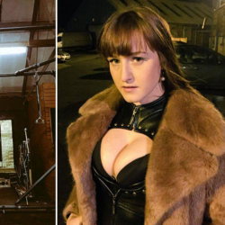 Woman with brown hair and bangs wears a black leather corset and fur coat, standing outdoors at night near parked