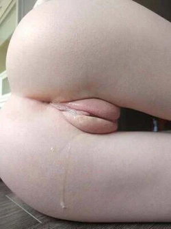 A person with a curvy body type lies on their side, wearing a thong.