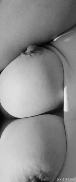 Close-up black and white image of a person's bare buttocks, showing skin texture and natural contours.